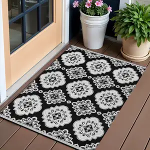 Photo of Black And Ivory Medallion Washable Indoor Outdoor Area Rug