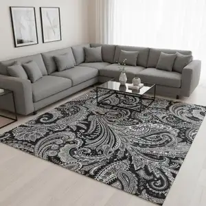 Photo of Black And Ivory Paisley Washable Area Rug With UV Protection