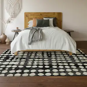 Photo of Black And Ivory Polka Dot Washable Area Rug With UV Protection