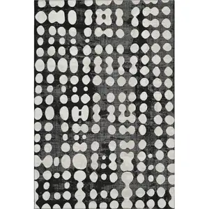 Photo of Black And Ivory Polka Dot Washable Area Rug With UV Protection