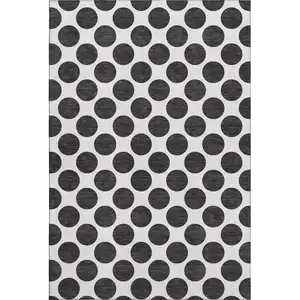 Photo of Black And Ivory Polka Dot Washable Area Rug With UV Protection
