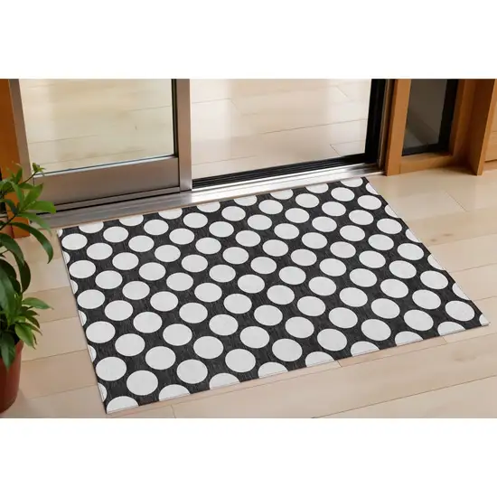 Black And Ivory Polka Dot Washable Indoor Outdoor Area Rug Photo 1