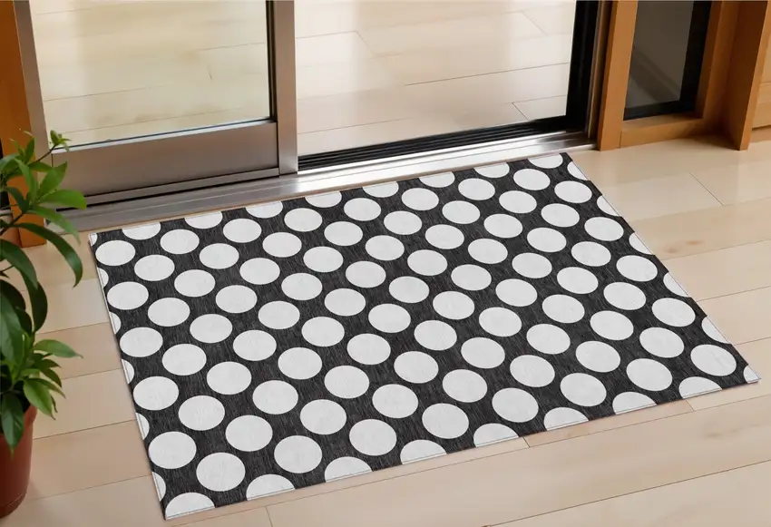 Black And Ivory Polka Dot Washable Indoor Outdoor Area Rug Photo 1
