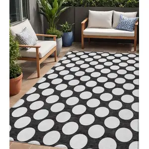 Photo of Black And Ivory Polka Dot Washable Indoor Outdoor Area Rug
