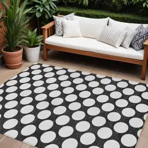 Photo of Black And Ivory Polka Dot Washable Indoor Outdoor Area Rug