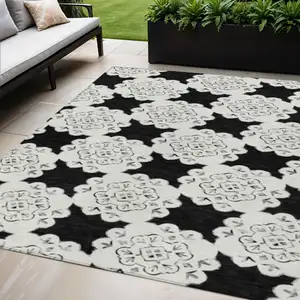 Photo of Black And Ivory Quatrefoil Washable Indoor Outdoor Area Rug