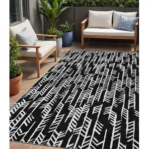 Photo of Black And Ivory Tribal Washable Indoor Outdoor Area Rug