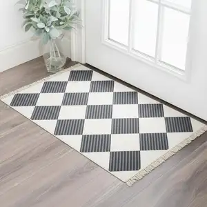 Photo of Black And Off White Geometric Washable Area Rug With Fringe