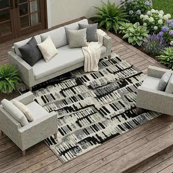 Black And Taupe Abstract Washable Indoor Outdoor Area Rug Photo 1