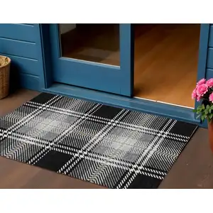 Photo of Black Gold And Gray Plaid Washable Indoor Outdoor Area Rug