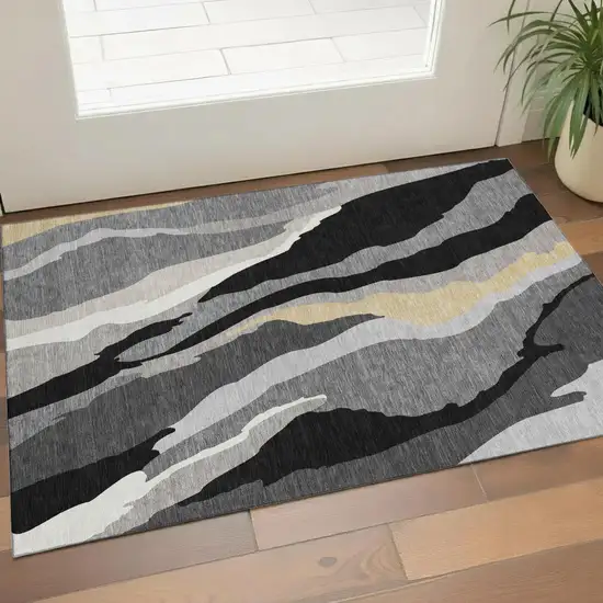 Black Gold And Ivory Abstract Washable Area Rug With UV Protection Photo 1
