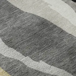 Photo of Black Gold And Ivory Abstract Washable Area Rug With UV Protection