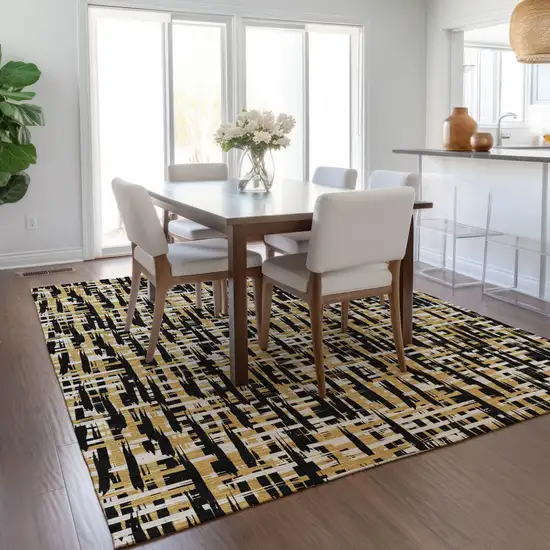 Black Gold And Ivory Abstract Washable Indoor Outdoor Area Rug Photo 9