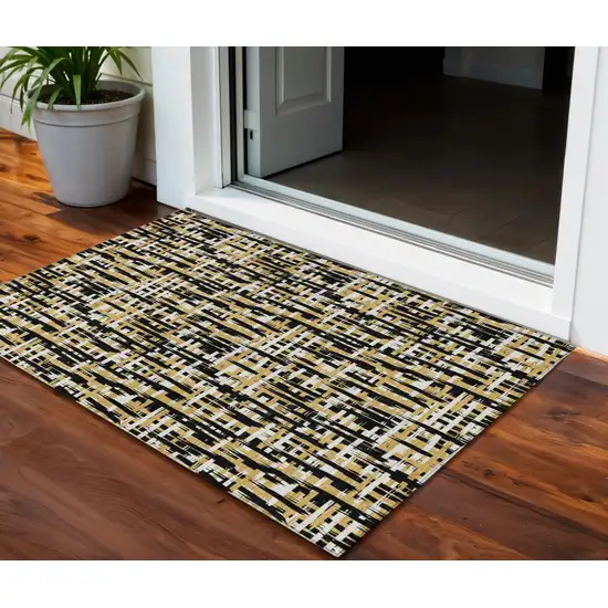 Black Gold And Ivory Abstract Washable Indoor Outdoor Area Rug Photo 1