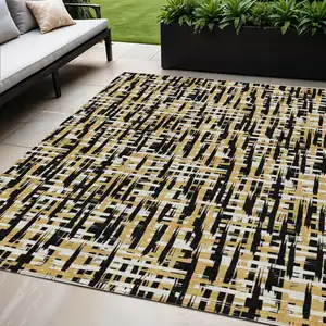 Photo of Black Gold And Ivory Abstract Washable Indoor Outdoor Area Rug