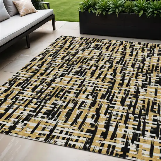 Black Gold And Ivory Abstract Washable Indoor Outdoor Area Rug Photo 1