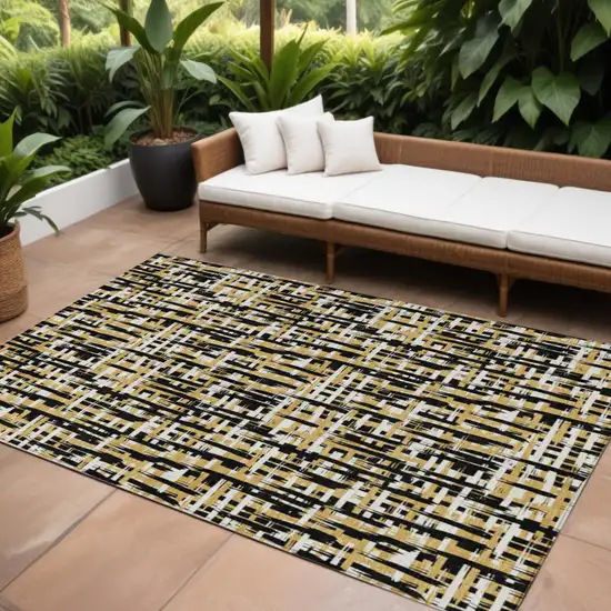 Black Gold And Ivory Abstract Washable Indoor Outdoor Area Rug Photo 1