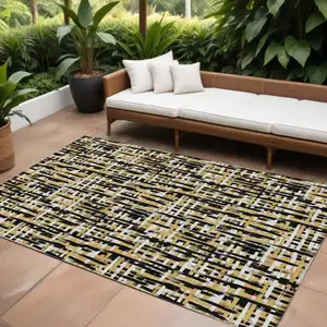 Photo of Black Gold And Ivory Abstract Washable Indoor Outdoor Area Rug