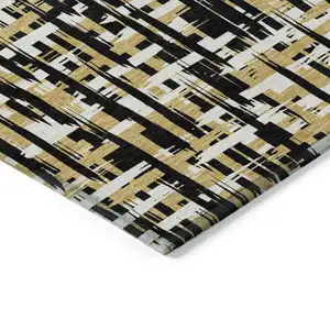 Photo of Black Gold And Ivory Abstract Washable Indoor Outdoor Area Rug