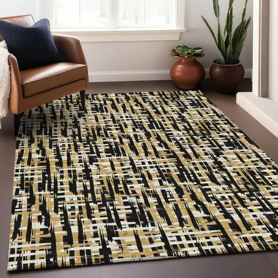 Black Gold And Ivory Abstract Washable Indoor Outdoor Area Rug Photo 9