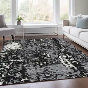 Photo of Black Gray And Ivory Abstract Washable Area Rug With UV Protection