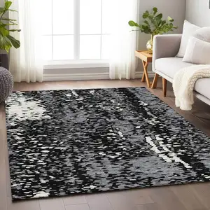 Photo of Black Gray And Ivory Abstract Washable Area Rug With UV Protection