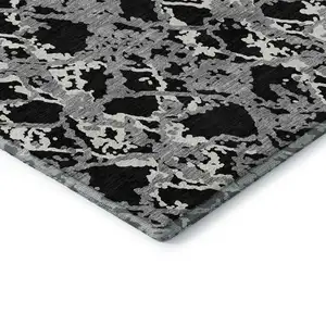 Photo of Black Gray And Ivory Abstract Washable Area Rug With UV Protection