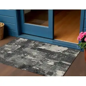 Photo of Black Gray And Ivory Abstract Washable Indoor Outdoor Area Rug