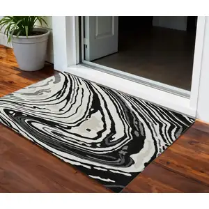 Photo of Black Gray And Ivory Abstract Washable Indoor Outdoor Area Rug