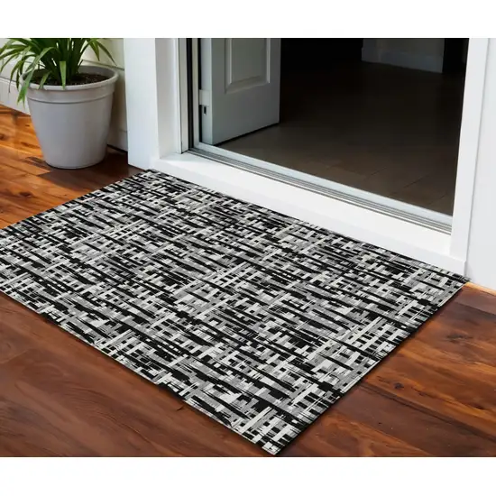 Black Gray And Ivory Abstract Washable Indoor Outdoor Area Rug Photo 1