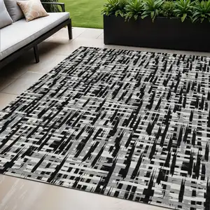 Photo of Black Gray And Ivory Abstract Washable Indoor Outdoor Area Rug