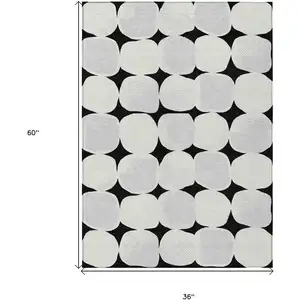 Photo of Black Gray And Ivory Abstract Washable Indoor Outdoor Area Rug