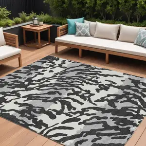 Photo of Black Gray And Ivory Animal Print Washable Indoor Outdoor Area Rug