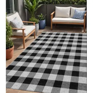 Photo of Black Gray And Ivory Plaid Washable Indoor Outdoor Area Rug