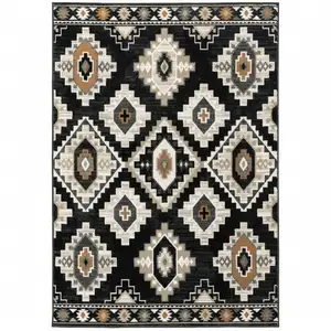 Photo of Black Grey Tan Orange And Ivory Southwestern Power Loom Stain Resistant Area Rug
