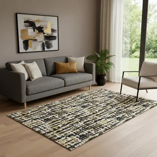 Black Ivory And Gold Abstract Geometric Washable Area Rug With UV Protection Photo 1