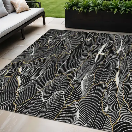 Black Ivory And Gold Abstract Washable Indoor Outdoor Area Rug Photo 1