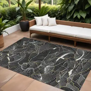 Photo of Black Ivory And Gold Abstract Washable Indoor Outdoor Area Rug