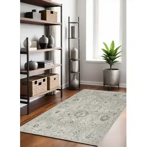 Photo of Black Mint Green And Ivory Floral Distressed Area Rug