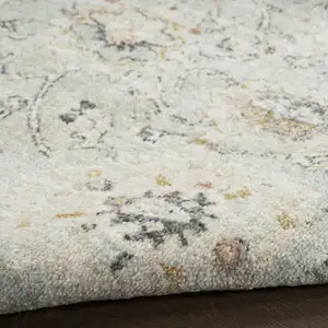 Photo of Black Mint Green And Ivory Floral Distressed Area Rug