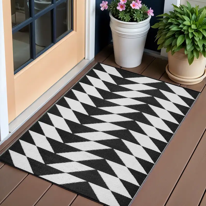 Black and White Geometric Machine Braided Distressed Area Rug With UV Protection Photo 1
