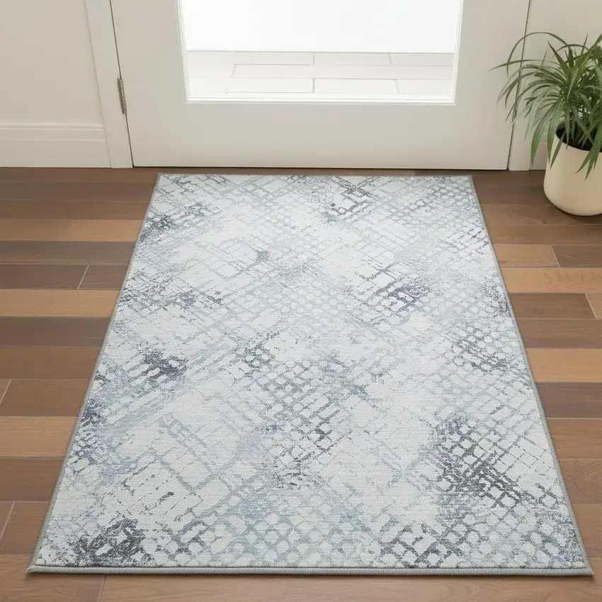 Blue And Ivory Abstract Geometric Washable Area Rug With UV Protection Photo 2