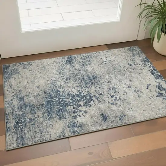 Blue And Ivory Abstract Washable Area Rug With UV Protection Photo 1