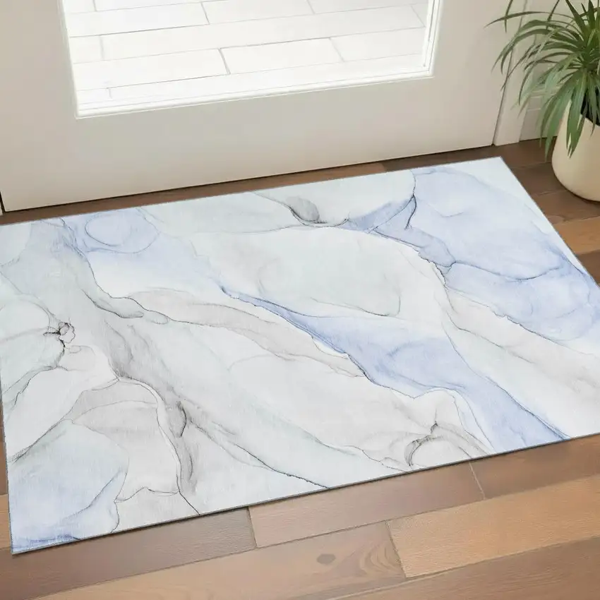 Blue And Ivory Abstract Washable Area Rug With UV Protection Photo 1