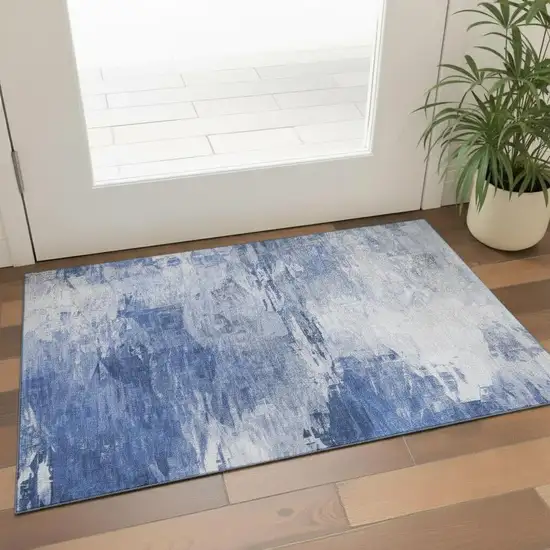 Blue And Ivory Abstract Washable Area Rug With UV Protection Photo 1