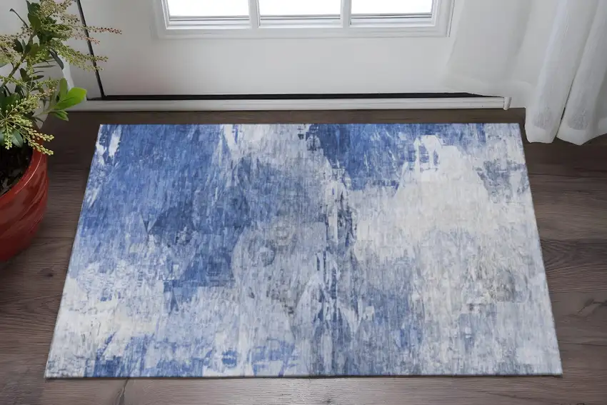 Blue And Ivory Abstract Washable Area Rug With UV Protection Photo 1