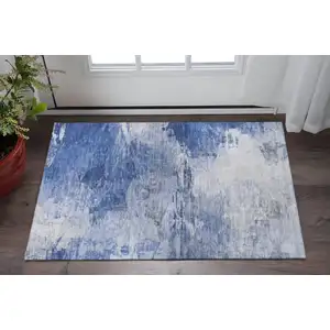 Photo of Blue And Ivory Abstract Washable Area Rug With UV Protection