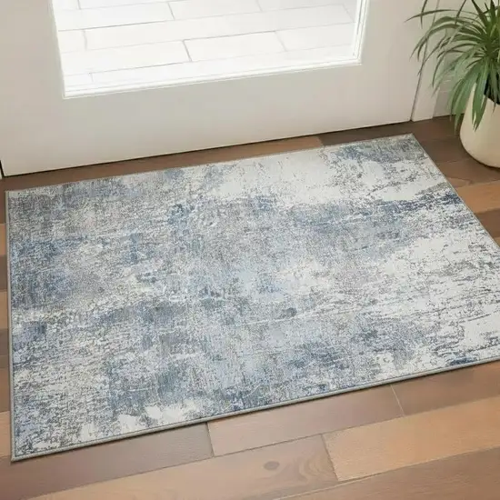Blue And Ivory Abstract Washable Area Rug With UV Protection Photo 1