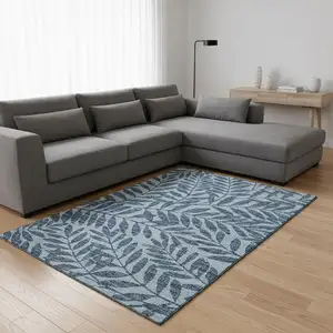 Photo of Blue And Ivory Botanical Leaves Washable Area Rug With UV Protection