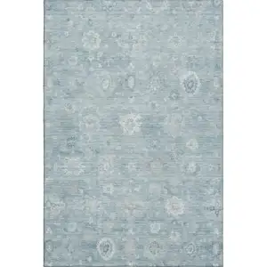 Photo of Blue And Ivory Damask Washable Area Rug With UV Protection